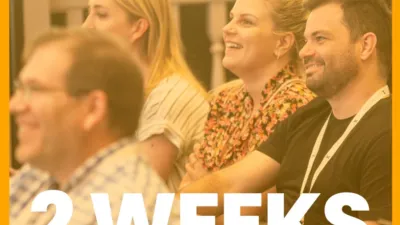 Orange graphic with CommCon logo, the text 'San Francisco' and 'Two weeks' on top of a photo of attendees at CommCon 2023 watching a talk and smiling.
